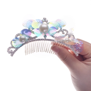 Sparkling mermaid hair comb crown with pearls and rhinestones on a white background