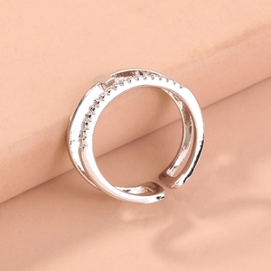 Detail of silver-tone open ring with double-layer cross band and white zircon stones