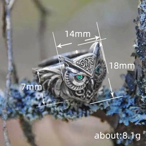 Vintage 3D owl ring in antique silver finish with green gemstone eyes on a branch