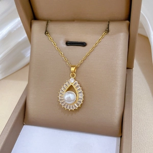 Macro shot of luxury gold waterdrop pearl necklace with sparkling zircon halo on silk
