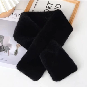 Detailed view of plush black faux mink fur scarf with soft texture in an aesthetic layout