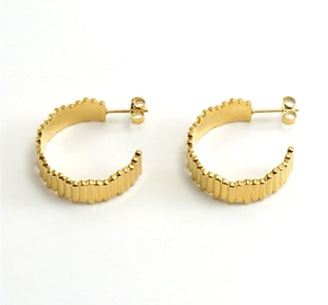 Detailed close-up of 18K gold plated C-shape earrings with a stylish rippled metal texture