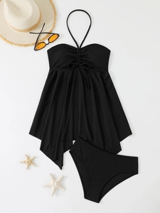 Flat lay of black rib-knit tankini set with halter neck and drawstring detail