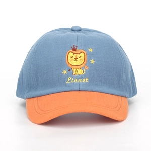 Detailed embroidery of a cartoon lion with crown on a blue and orange kids baseball cap