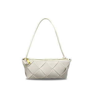Macro detail of white woven leather handbag texture with a gold zipper on shoulder bag
