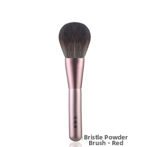Macro shot of dense synthetic bristles and gradient metal handle of the makeup brush