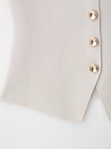 Detailed macro view of knit vest with gold buttons and soft oatmeal fabric texture