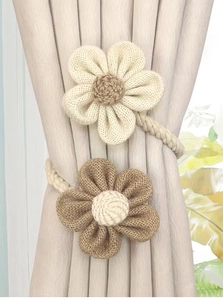 Handmade burlap flower curtain tieback in beige and brown jute fabric showing rustic texture