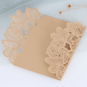 Detailed laser-cut champagne gold wedding invitation card with intricate floral patterns