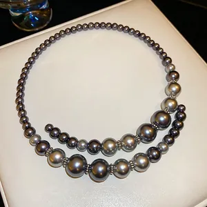 French style double-layer dark gray faux pearl necklace with metallic accents on white leather