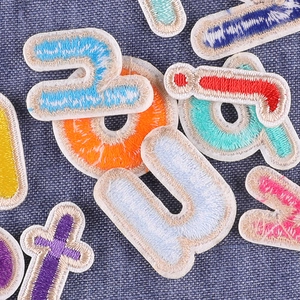 Colorful embroidered iron-on letter patches for personalized clothing and uniforms