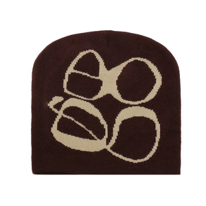 Close-up of Y2K gothic jacquard knit beanie in dark brown with cream eyewear pattern