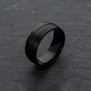 Three-piece black matte stainless steel ring set with brushed finish on stone background