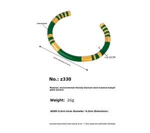 Detailed macro view showing the 0.6cm width and green enamel coating on the gold steel bangle
