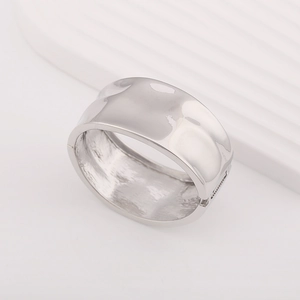 Detailed close-up of a silver hammered texture bangle with a functional hinge clasp