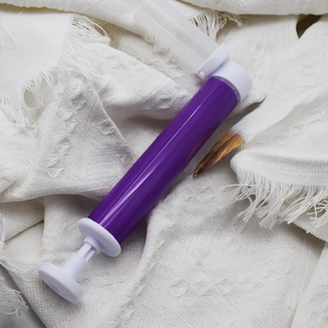 Manual cake airbrush gun in purple for mousse coloring and kitchen baking decoration