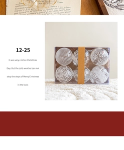 Set of 6 clear Christmas ornaments with white snow patterns in a brown gift box