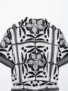 Detail shot of Cuban collar and tropical botanical print on women short romper