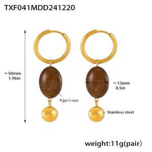 Detail of vintage 18k gold plated stainless steel earrings with natural tiger eye stone