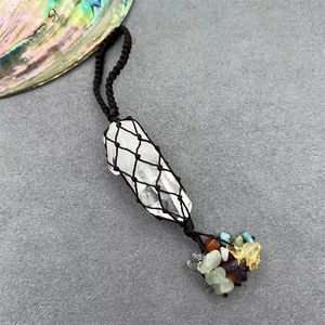 Vue macro du pendentif en cristal tressé avec quartz blanc et pierres multicolores