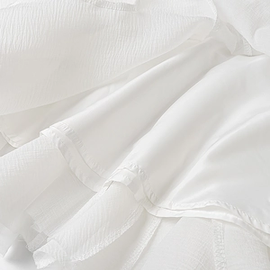 Detailed macro view of white pleated fabric with smooth silky lining and texture