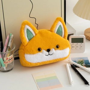 Close-up of a cute orange fox plush pencil case with soft texture on a cozy desktop