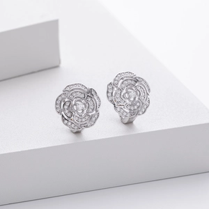 Close-up of S925 silver camellia flower earrings set with sparkling cubic zirconia stones