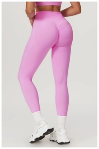 Macro detail of high-waist seamless pink yoga pants featuring scrunch butt lifting texture