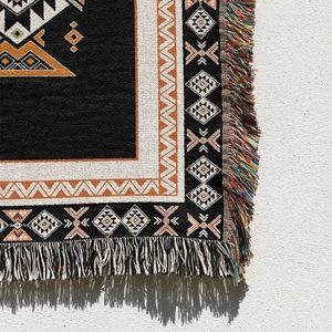 Detail of bohemian geometric knit blanket with ethnic patterns and tassels