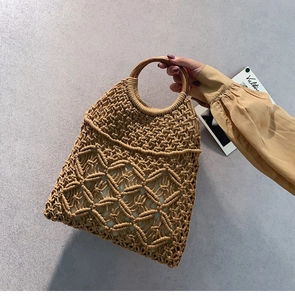 Detail of bohemian cotton woven bag with wooden handle and inner lining for beach holidays