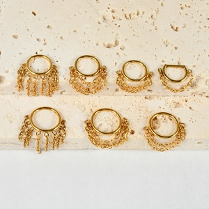Detailed view of seven gold-plated stainless steel nose rings with chain fringe on stone