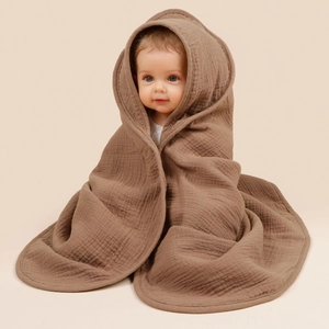 Detailed macro view of brown four-layer cotton muslin gauze baby hooded towel fabric texture