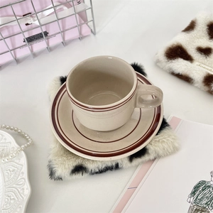 Close-up of heart-shaped leopard print plush coaster with vintage ceramic coffee cup set