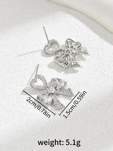 Close-up of bow earrings with heart-shaped zircon and detailed size dimensions