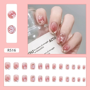 Pink gradient press-on nails with white cherry blossoms and gold wire French tip design