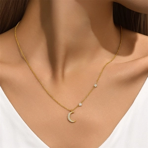 Macro detail of gold S925 sterling silver necklace with moon and star pendants