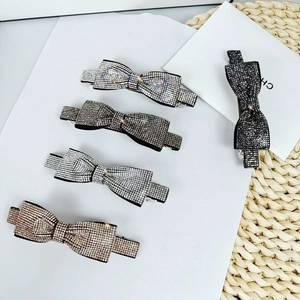 Sparkling crystal bow hair clips in silver and champagne tones for elegant hairstyles