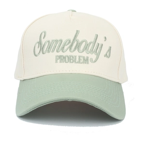 Detail of embroidered Somebody's PROBLEM text on two-tone canvas trucker cap