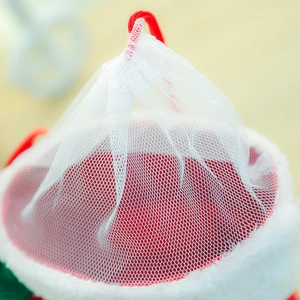Macro shot of white mesh texture and red flocked fabric on a Christmas candy boot
