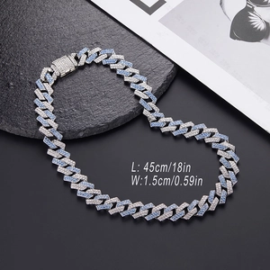 Men's 15mm hip hop Cuban link chain with blue and silver crystals on a black slate