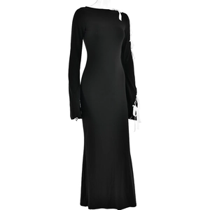 Detail of black off-shoulder dress featuring unique white lace-up sleeve ties and slim fit