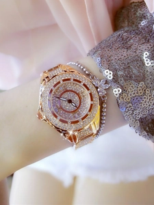 Close-up of rose gold full diamond watch paired with a silver bow beaded bracelet