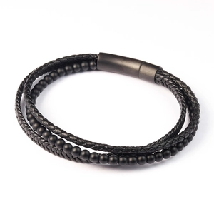 Detail of men's multilayer black braided leather bracelet with matte magnetic clasp