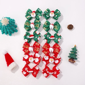 Christmas bow hair clips for kids with 12 pieces featuring Santa and polar bear dolls
