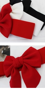 Detailed view of elastic waistbands with large 3D bows in red, white and black colors