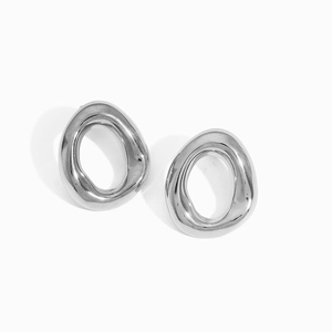 Macro detail of irregular hollow silver earrings in minimalist liquid metal design