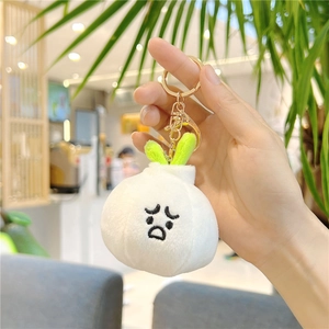 Cute garlic plush keychain with sad expression and gold ring for bags and keys