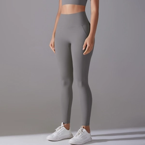 Detail of high-waisted seamless yoga pants in dark grey with elastic compression fabric