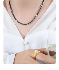 Detail of beaded necklace with faceted phoenix lapis and pearls paired with gold pearl ring