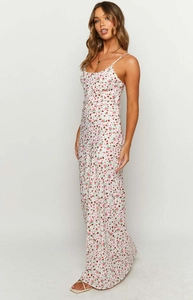 Detail of floral spaghetti strap jumpsuit showing side waist cut and elegant drape